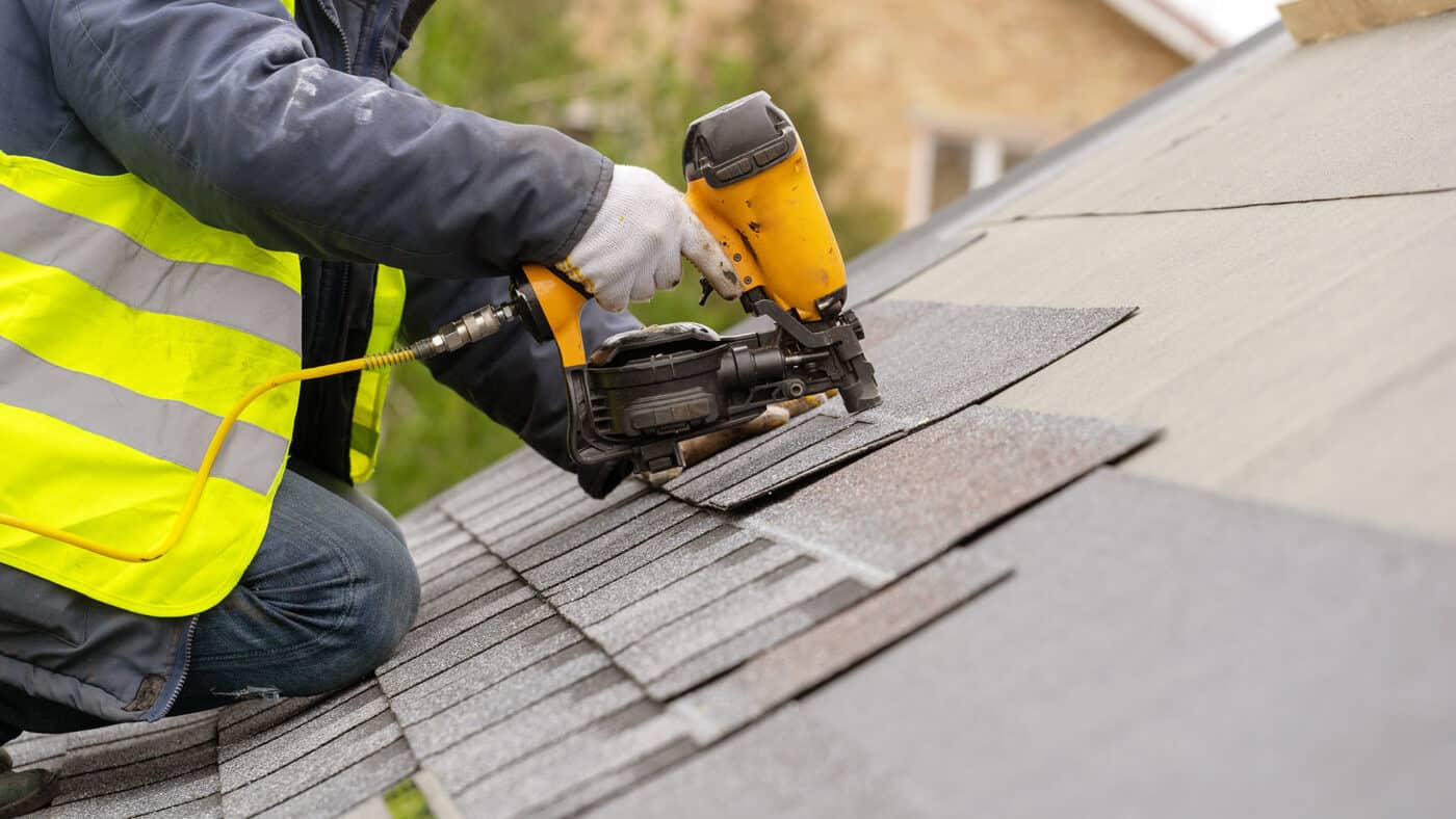 Roofer working with specialist roofing and cladding tools